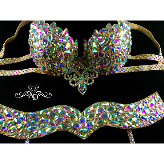 Golden belly dance bra, belt, and hip garters set on golden fabric base
