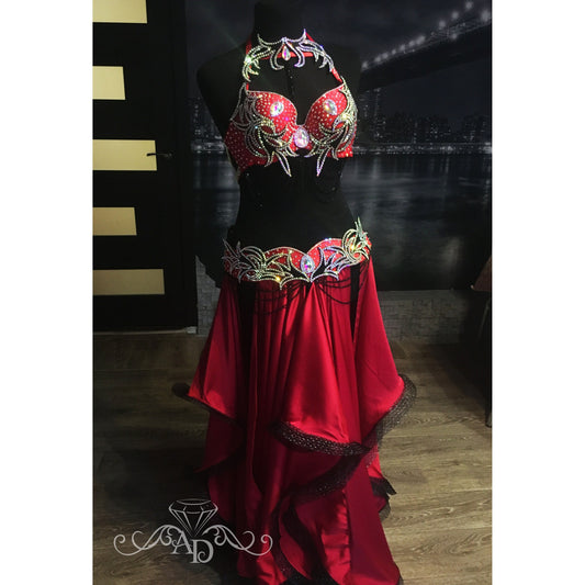 Red flame belly dance costume on mannequin with rhinestones and satin layered skirt