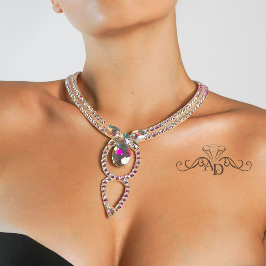 Elegant necklace with a large pendant worn by a model on a plain background