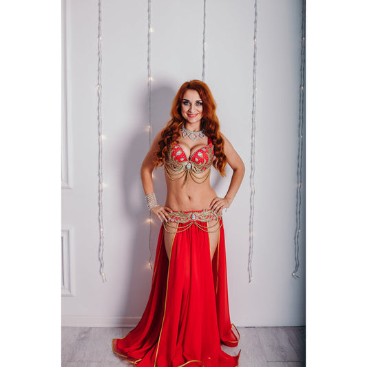Woman in a red and gold custom belly dance costume with chiffon skirt and gold embroidery